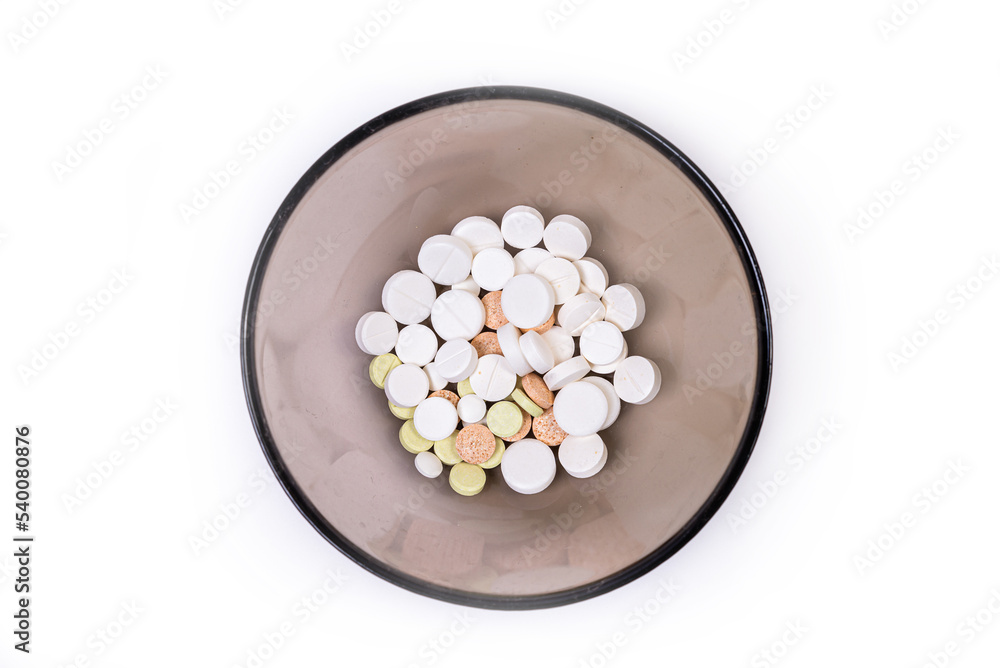 Medical pills on a white background in a plate Medical pills on a white background in a plate