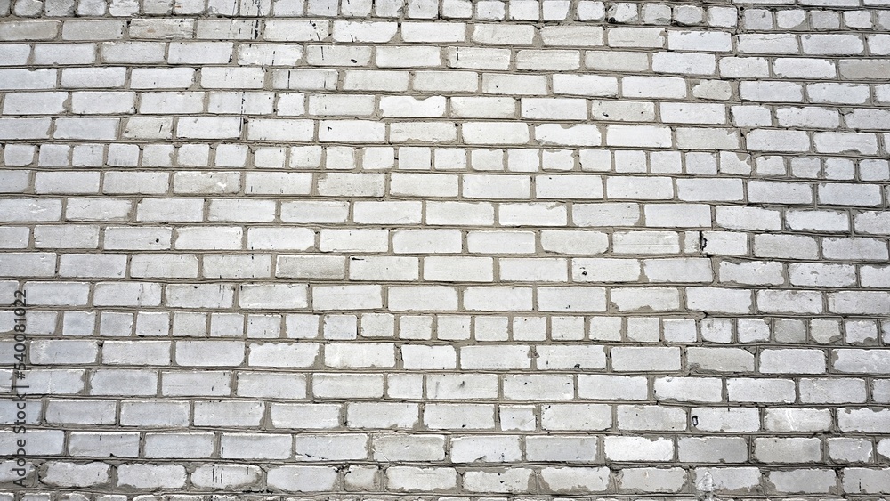 texture of an old uneven gray brick wall, a lot of bricks close-up