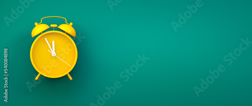 Yellow vintage alarm clock on color background - hurry up, last chance concept with copy space photo