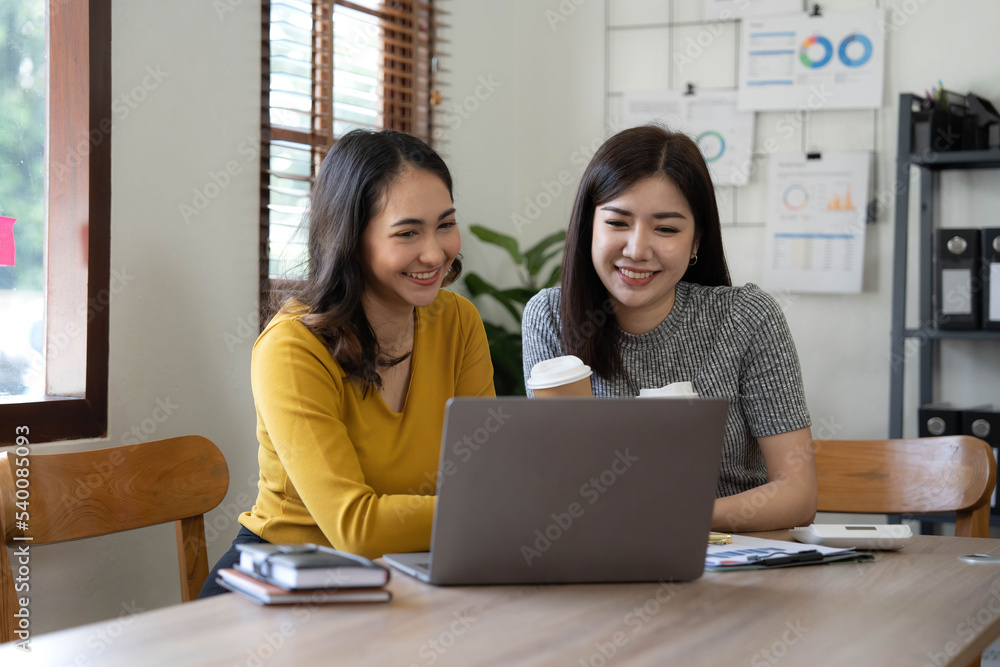 Two young Asian business woman talk, consult, discuss working with new startup project idea presentation analyze plan marketing and investment in the office. Two young Asian business woman talk, consult, discuss working with new startup project idea presentation analyze plan marketing and investment in the office.