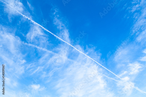 Background or wallpaper blue sky with clouds, photo taken in sunny day, flight trail, chemtrails