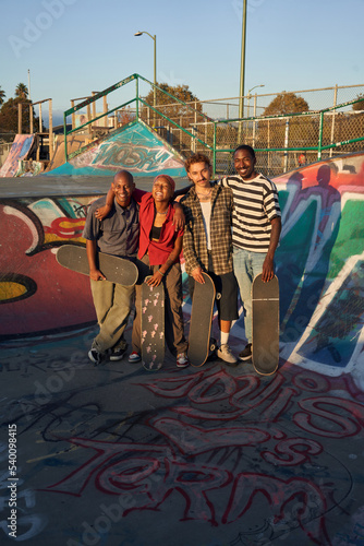 Portrait of four young skateboarders at the skatepark 
