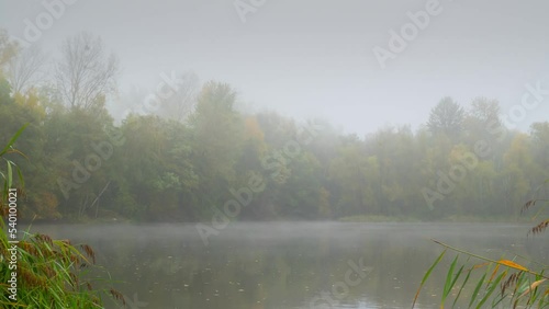 Mysterious forest lake with fog Timelapse 03 - Pan right photo