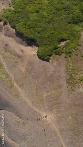 Vertical aerial footage of the trail to the bottom part of the Quetrupillan volcano in Chile photo