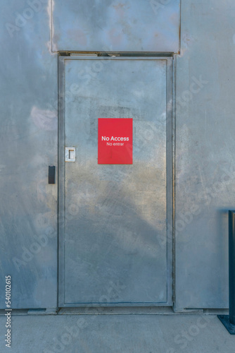 Fototapeta Naklejka Na Ścianę i Meble -  Bright red No Access signage on a shiny door at Waterloo Park Austin Texas