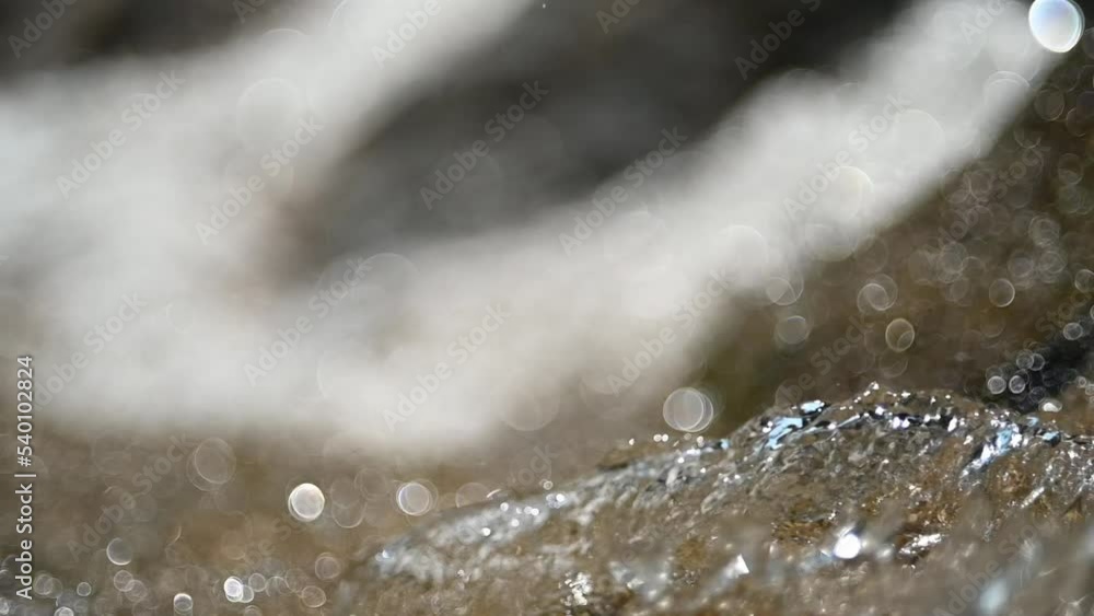 Bubble bokeh of waterfalls and abstract water figures (slow motion)