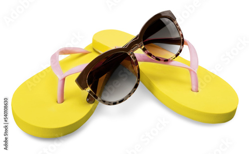 Yellow flip flops and sunglasses on white