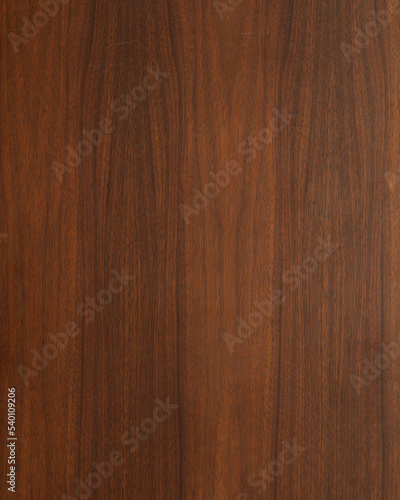 Wood texture background. Walnut surface from a mid-century modern gentleman's chest. Vertical wood grain banner. 