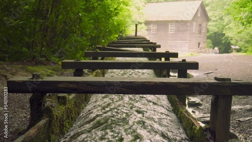 Mingus Mill at Great Smoky Mountains National Park. Water flows down a millrace to the mill. Historic gristmill was used for corn meal milling.  photo