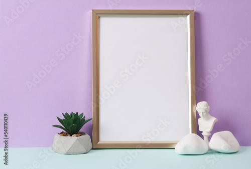 Photo frame with a white sheet of paper (mockup) and decor on a pastel background. Minimal still life