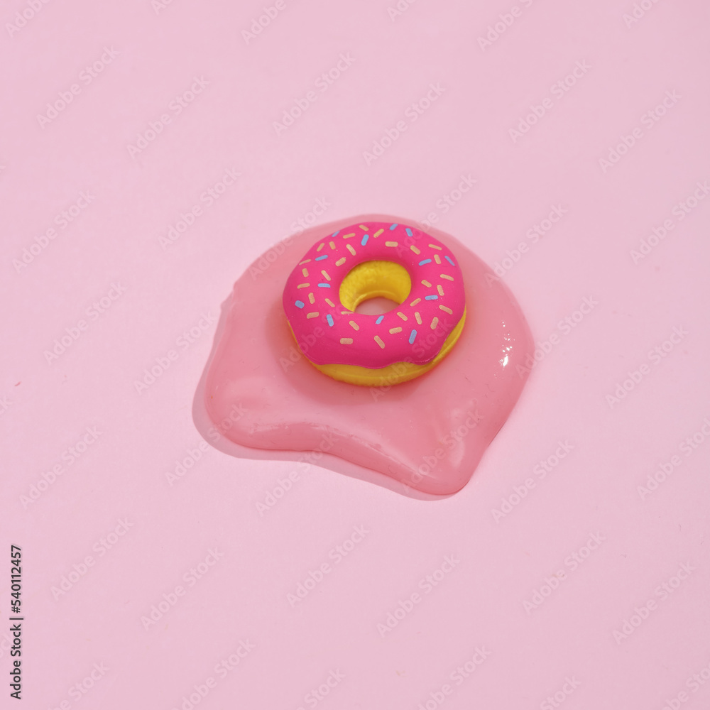 Miniature melted donut on pink background Miniature melted donut on pink background