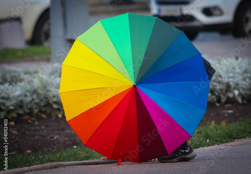 Umbrella in the colors of the rainbow (LGBT) on the street during the day © olegdubyna