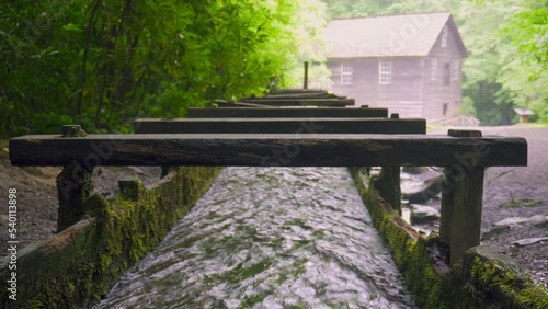 Mingus Mill at Great Smoky Mountains National Park. Water flows down a millrace to the mill. Historic gristmill was used for corn meal milling. photo