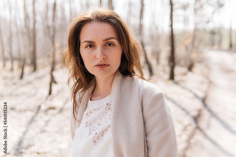 Beautiful girl in a white dress and a beige coat in a spring birch grove. High quality photo Beautiful girl in a white dress and a beige coat in a spring birch grove. High quality photo