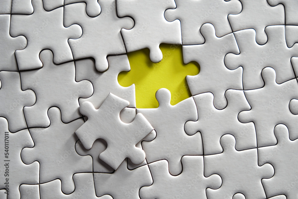 blank jigsaw puzzle against yellow background blank jigsaw puzzle against yellow background