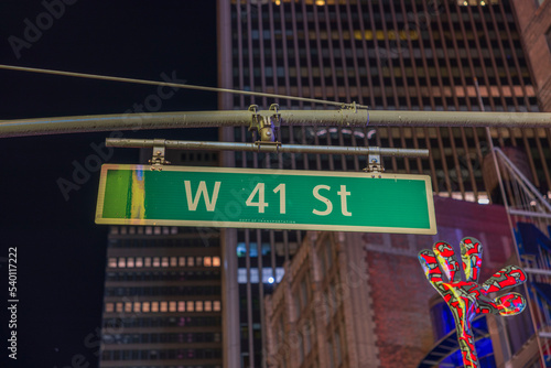 Beautiful night city view of tops of buildings and West 41st Street sign. New York. USA. photo