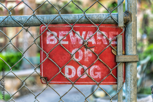 Wall Mural Beware of dog sign on a chain link fence in the suburbs of San Antonio Texas