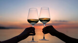 Hands making cheers with wine in glass against the sea