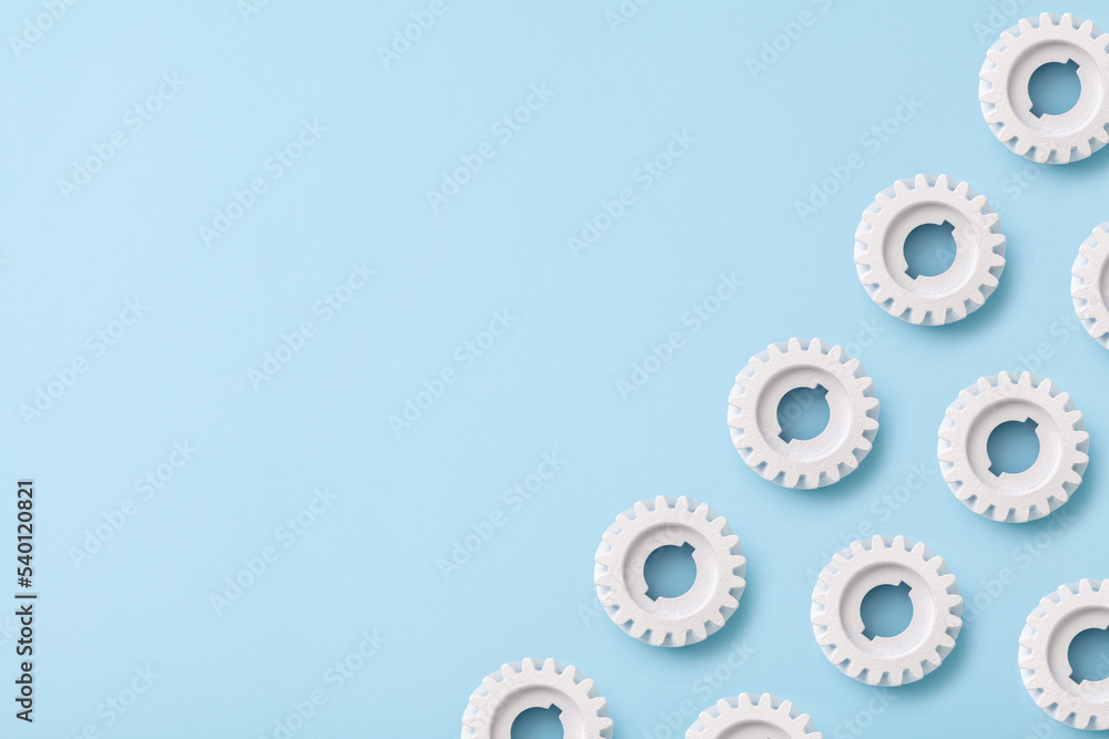 Flat lay white gears wheels symbolizing idea, cooperation, teamwork and connection concept Flat lay white gears wheels symbolizing idea, cooperation, teamwork and connection concept