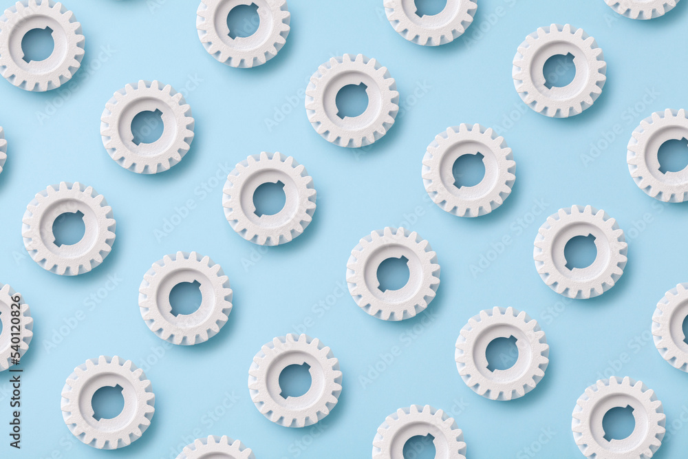 Flat lay white gears wheels symbolizing idea, cooperation, teamwork and connection concept Flat lay white gears wheels symbolizing idea, cooperation, teamwork and connection concept