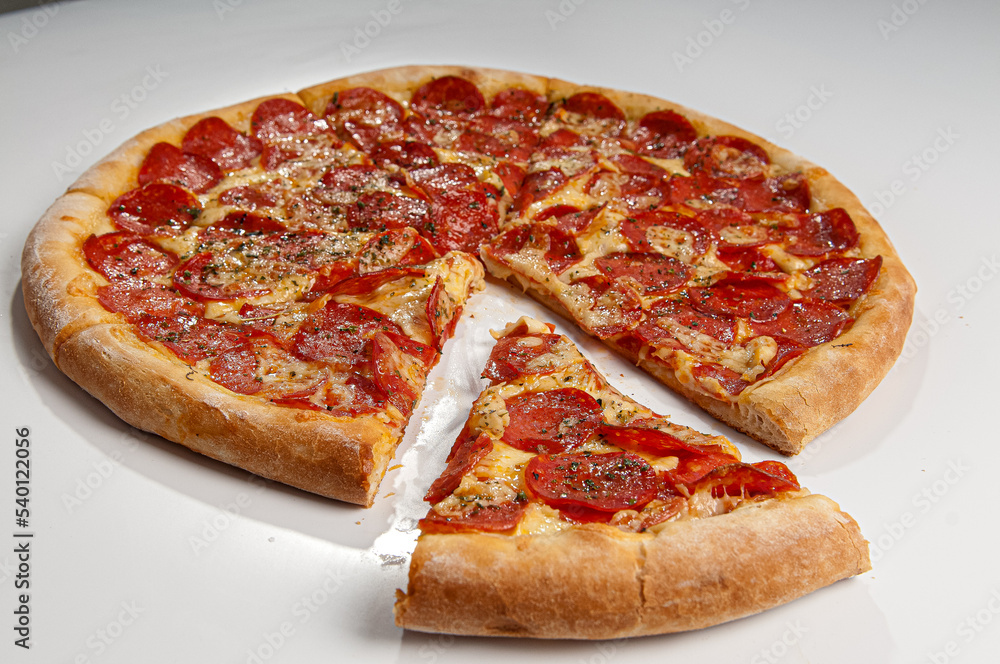 ..Pepperoni pizza on white background. Copy space. Selective focus