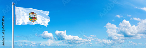 Baja California, state of Mexico - flag waving on a blue sky in beautiful clouds - Horizontal banner
 photo
