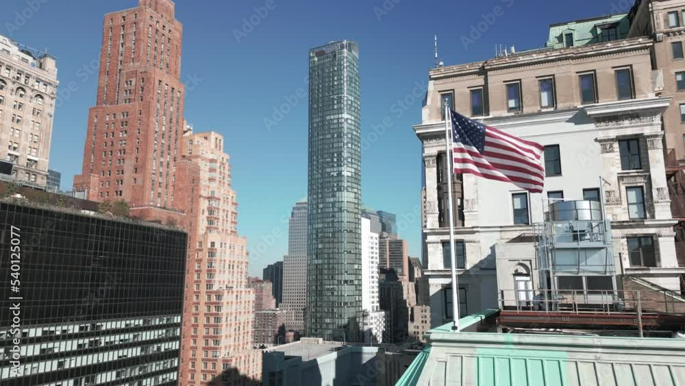 flying past American flag towards view of downtown NYC skyline flying past American flag towards view of downtown NYC skyline