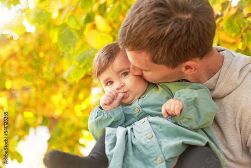 Happy father play with the baby. The man holding the toddler in the hands and have fun