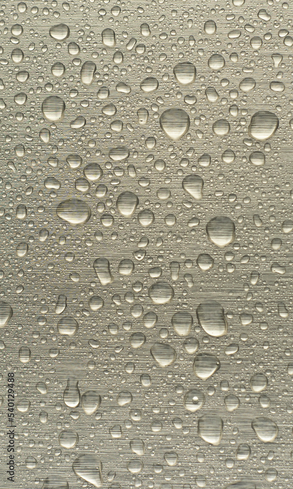 Raindrops on a metal surface. Vertical photo.Wallpapers for your smartphone. Round drops of water on a chrome film. Raindrops on a metal surface. Vertical photo.Wallpapers for your smartphone. Round drops of water on a chrome film.