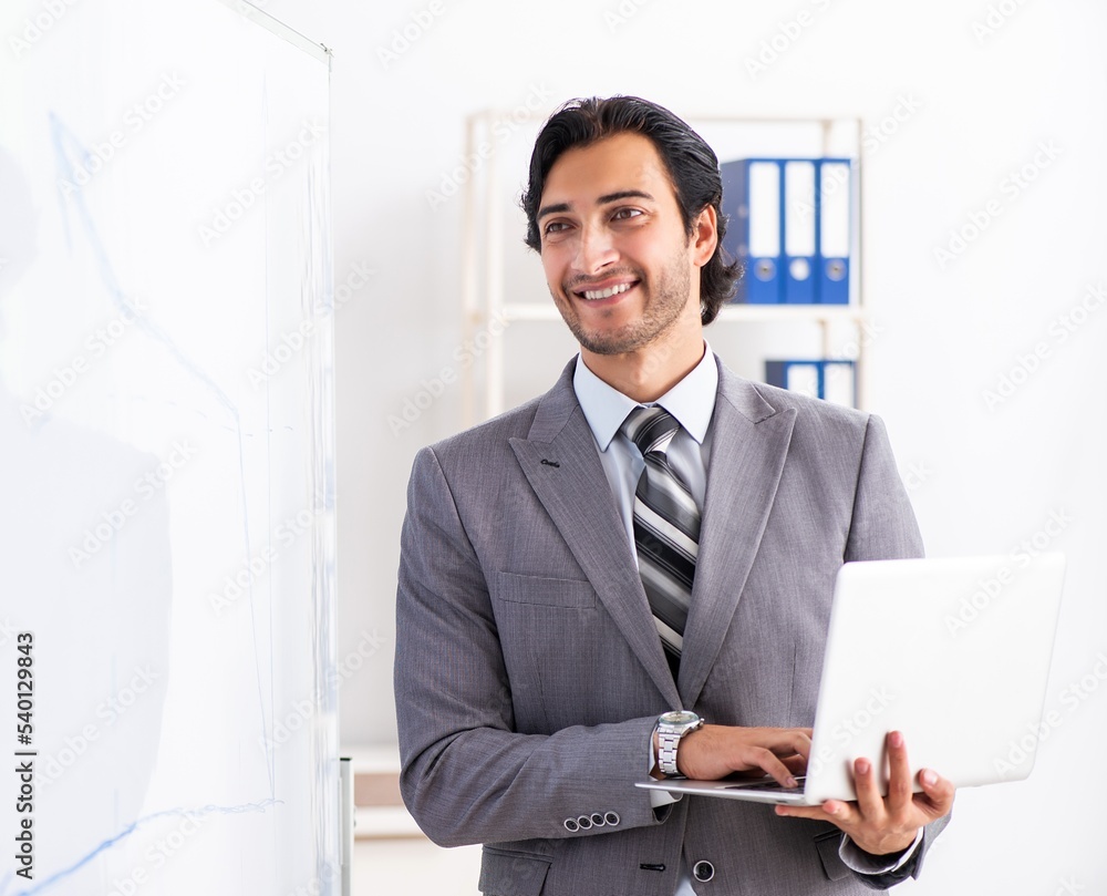 Young handsome businessman in front of whiteboard Young handsome businessman in front of whiteboard