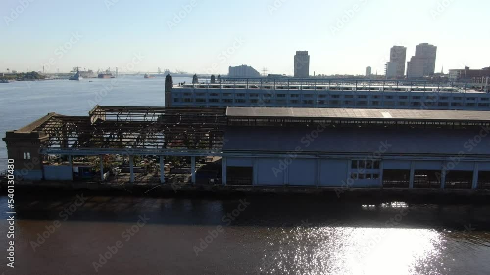 View of Cherry Street Pier in the center. An aerial photo shows the buildings of Philadelphia, near the Ben Franklin Bridge over the Delaware River. In the distance, the battleship USS New Jersey. View of Cherry Street Pier in the center. An aerial photo shows the buildings of Philadelphia, near the Ben Franklin Bridge over the Delaware River. In the distance, the battleship USS New Jersey.