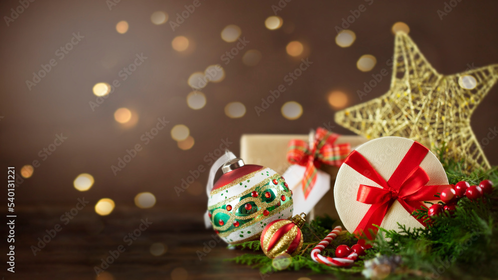 Christmas presents on wooden desk with defocused bokeh on background