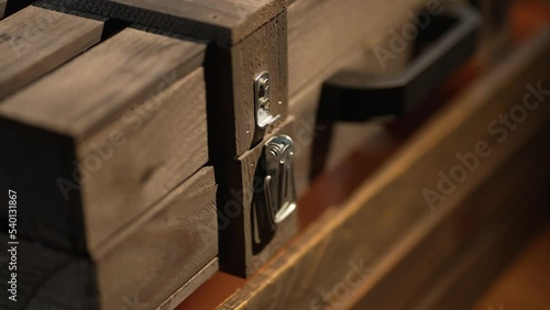 A man opens a wooden box