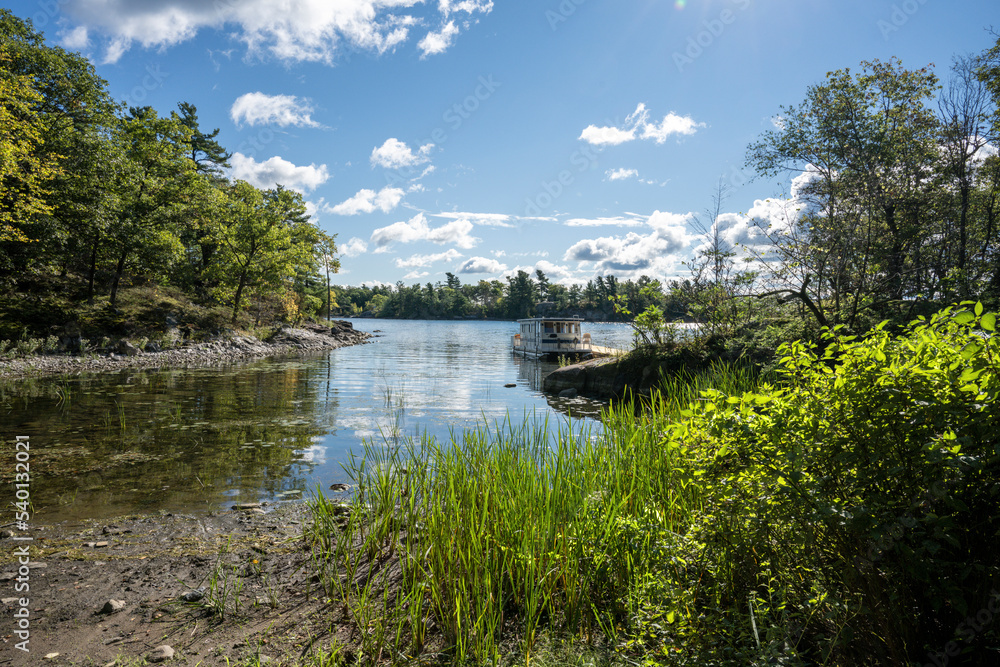 Waterfront summer scene with a houseboat