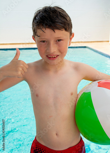Portrait of a little boy in swimming shorts.