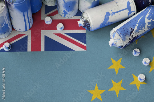 Tuvalu flag and few used aerosol spray cans for graffiti painting. Street art culture concept photo