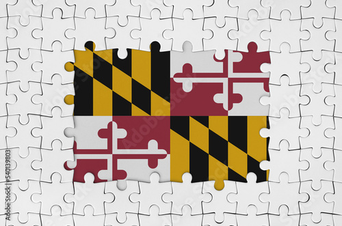 Maryland US state flag in frame of white puzzle pieces with missing central part photo