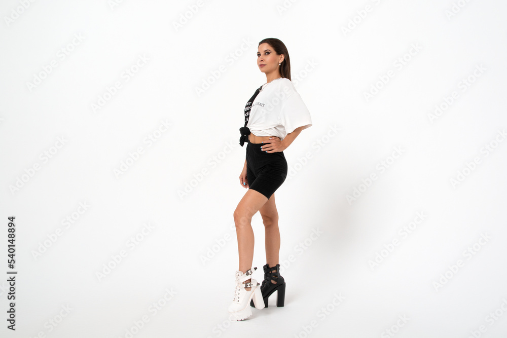 a girl in black and white clothes and shoes on a white background