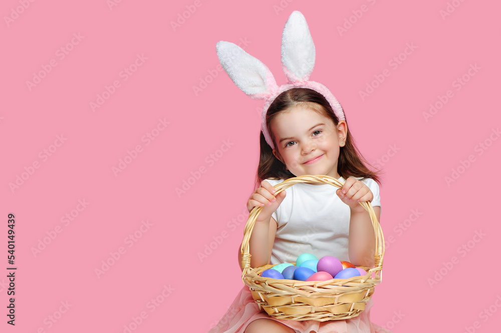 Happy smiling girl with Easter bunny  headband with  her basket with eggs