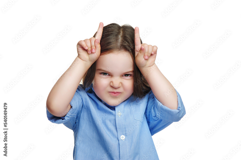 Little girl making teasing gesture with horns Little girl making teasing gesture with horns