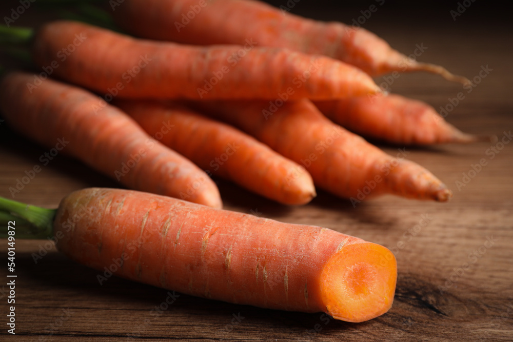 Ripe fresh carrot on wooden table, closeup Ripe fresh carrot on wooden table, closeup