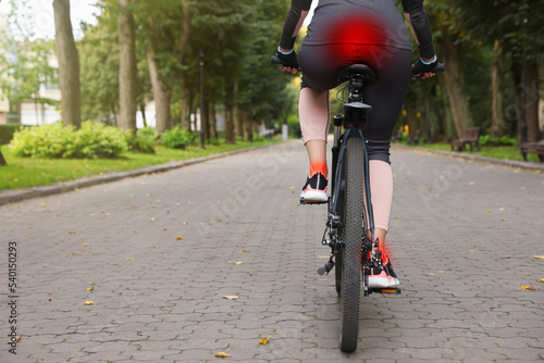 Photos Problem of injured coccyx. Woman riding bicycle on road