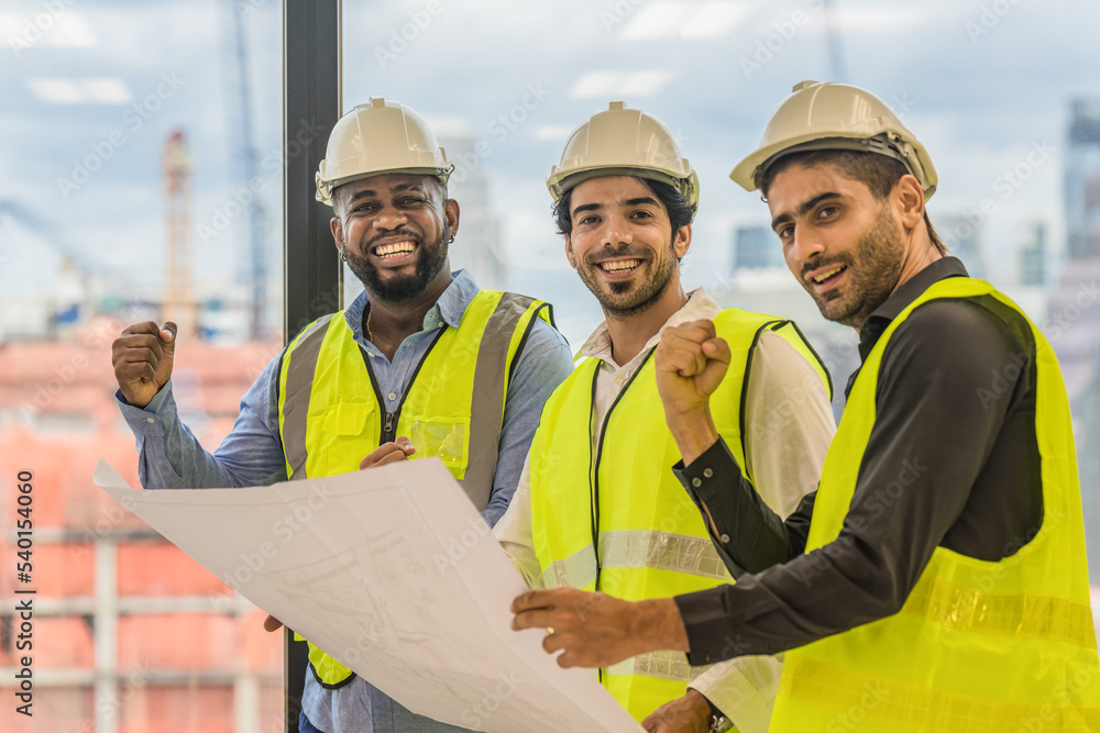 three civil engineer standing together raise fist up to show teamwork and confident three civil engineer standing together raise fist up to show teamwork and confident