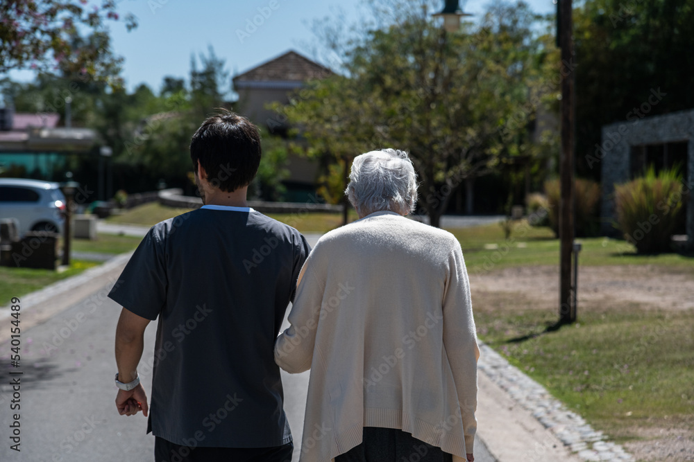 elderly grandmother and young grandson walking and spending time together therapeutic