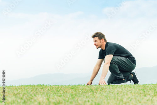 公園で短距離走・全速力で走る練習をするスポーツウェアを着た陸上選手の白人男性  © buritora