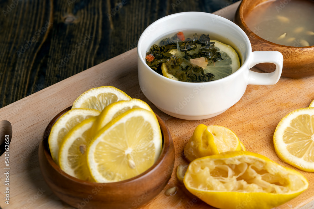 Green tea in a white cup during its brewing Green tea in a white cup during its brewing