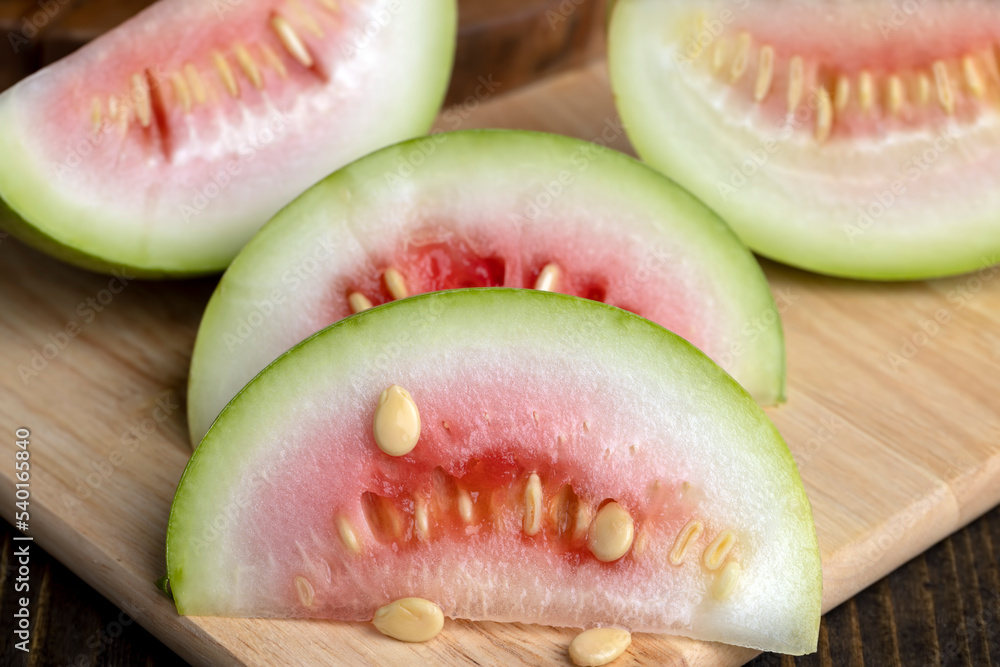 cut small unripe watermelon on a board