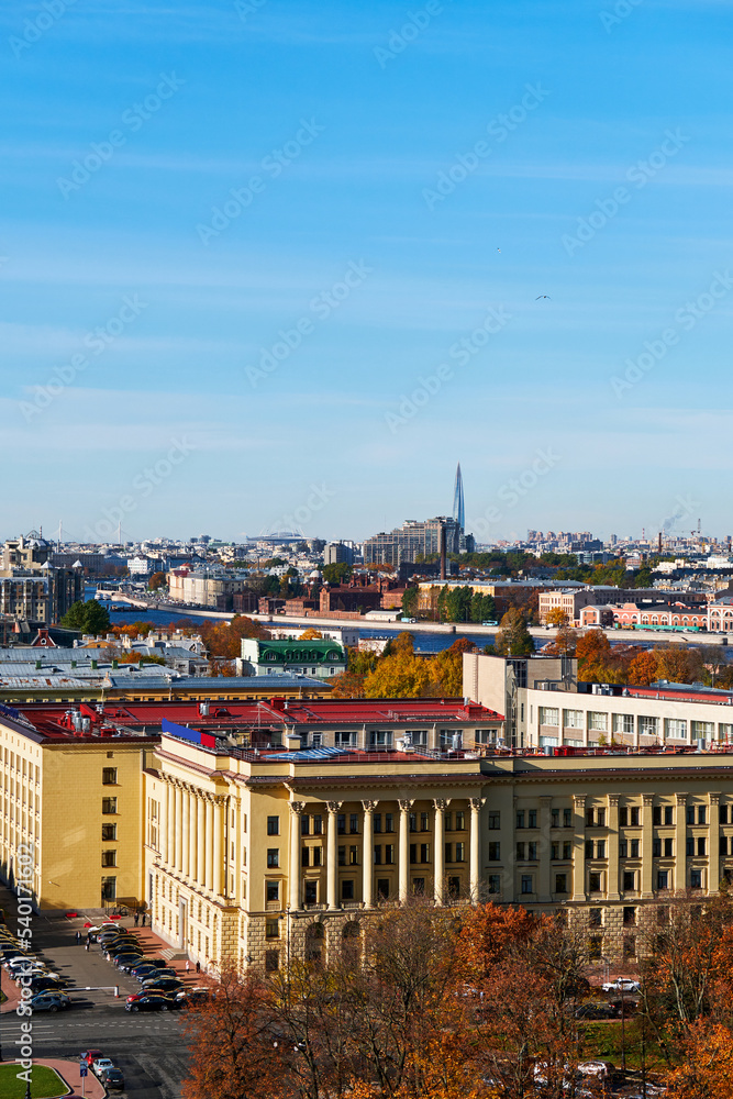 Blue sky over European city. Old city in autumn, vertical.