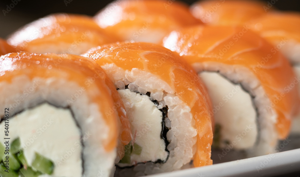 Philadelphia sushi roll with salmon on a white plate. japan restaurant menu Philadelphia sushi roll with salmon on a white plate. japan restaurant menu