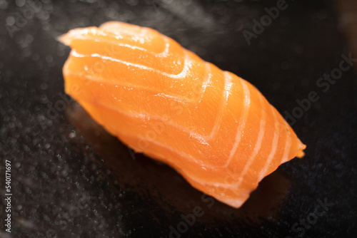 Classic sushi nigiri with salmon on black background. Japanese cuisine.